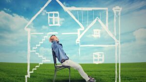 Graphic of man on chair in drawn house in a field