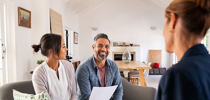 Middle aged couple at home meeting with mortgage broker