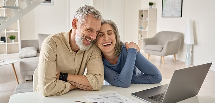 Older couple at home meeting online with a mortgage broker