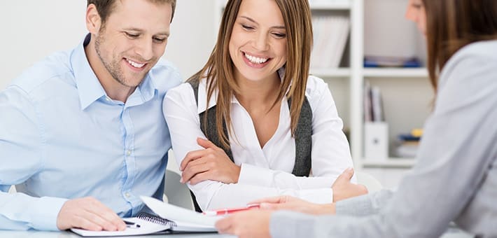 Young couple in a local office meeting with a mortgage broker