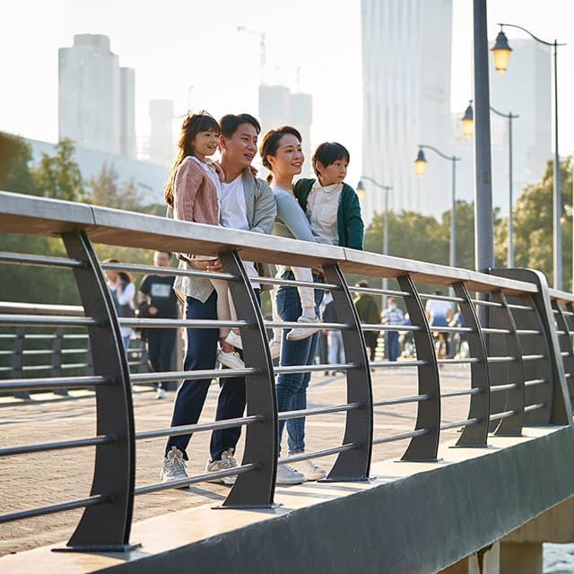 Non Resident family on bridge in city park