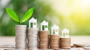 Financial property growth concept of houses on stacks of coins