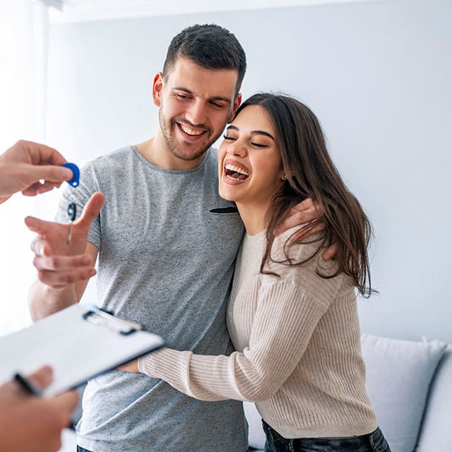 Young couple getting key to new home