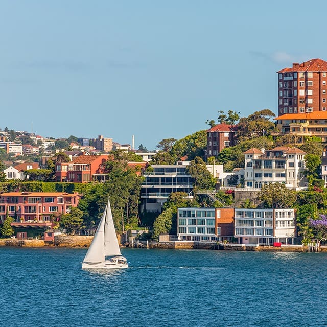 Waterfront homes and apartments with yacht in foreground