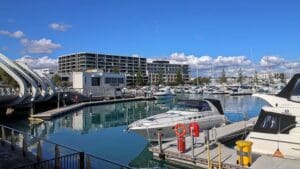Perth, Western Australia, Australia - June 17 2024: Luxury and wealth, modern waterfront apartment blocks, moored boats and yachts, Port Coogee Marina, City of Cockburn, Perth, Western Australia